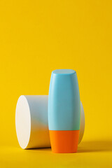 Blank tube with cosmetic product for moisturizing on yellow background