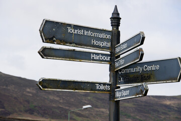 Old tourist sign post in Portree, Isle of Skye, Scotland