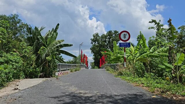 Rural street scene and bridge in Mang Thit district, Vinh Long province.  