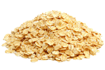 Golden mountain of oat flakes a breakfast staple against a stark isolated white background