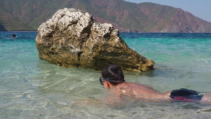 Snorkeling, swimming, summer activity on beach, water sports concept. Boy with snorkel and mask...