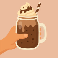 Illustration of a chocolate drink with whipped cream in a glass mug with a straw, held in a hand. 
