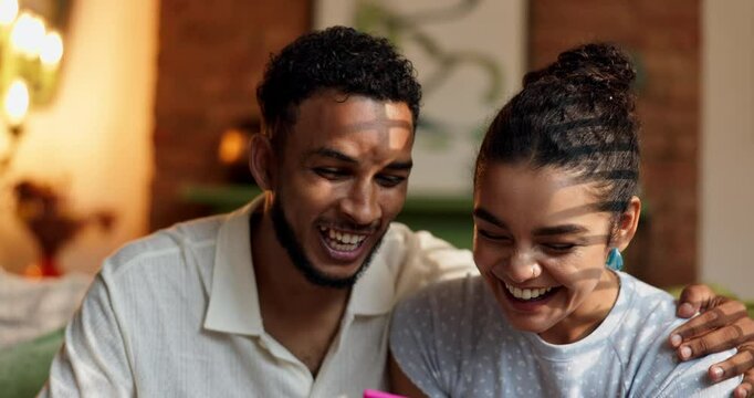Couple, pregnancy test and happy with results in home, positive or good news for fertility, maternity and start family. Man, woman and new parents with stick for support, excited and IVF success