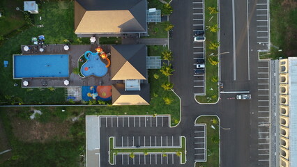 Aerial View of Modern Recreation Center: High-angle shot depicts a modern recreational center with swimming pool, parking area, and buildings, illustrating a well-planned outdoor space. 