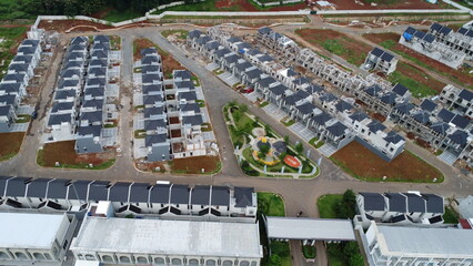 A picturesque aerial view showcases a newly developed residential area, with rows of modern houses arranged in an organized layout