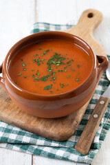 Traditional Spanish Gazpacho soup in bowl on white wooden table