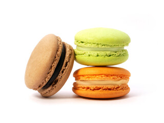 Pile of macaron cookies in various flavours and colours isolated on white background.
