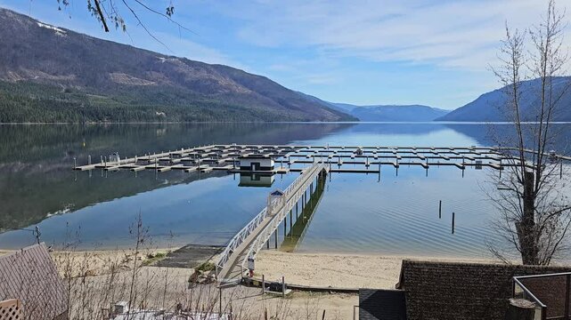 Empty docking pier in early spring during a calm day in Kingfisher, Canada Mable lake resort and marina