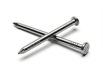 Two metallic nails crossed on a white surface, showcasing their sharp points and textured heads for construction use