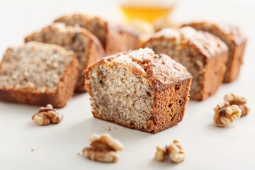 Freshly baked gluten free banana bread with walnuts and honey on a plain white background