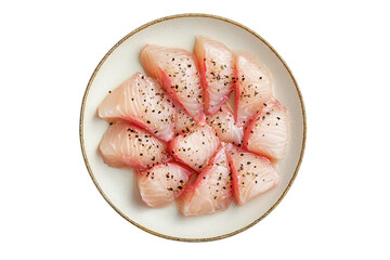 Fresh fish with black pepper on a speckled plate against a white backdrop