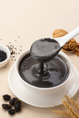 A bowl of black sesame paste mixed with five kinds of black ingredients.