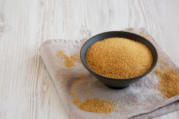 Organic Demerara Sugar in a Bowl, side view. Copy space.
