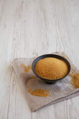 Organic Demerara Sugar in a Bowl, side view. Copy space.
