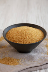 Organic Demerara Sugar in a Bowl, side view. Close-up.