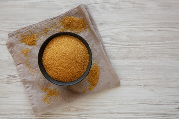 Organic Demerara Sugar in a Bowl, top view. Copy space.