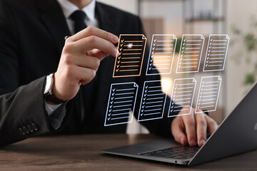 Man approving documents on virtual screen above laptop at table, closeup