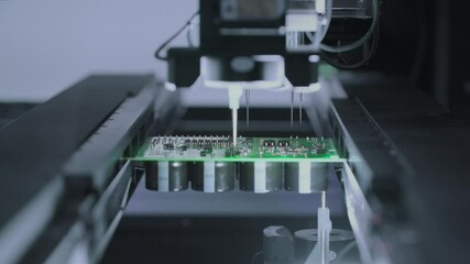 Close-up: installing electronic components. Printed circuit board moves with SMD, PCB. Automatic welding, solder machine. Production Devices. Diagnose test chips and processors. Manufacture or factory - Powered by Adobe