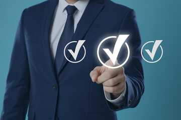 Approved. Man touching check mark on virtual screen against pastel blue background, closeup
