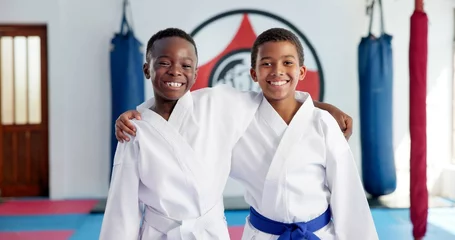 Fotobehang Vechtsporten Hug, karate and portrait of friends in dojo for martial arts, self defense or sports training. Development, fitness and smile of student children embracing in class together for exercise or support  © peopleimages.com