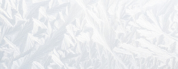 Fototapeta premium Abstract white ice texture with subtle frosty patterns and opacity variations, soft diffused lighting, slightly textured surface, creating a minimalist and ethereal panoramic background.