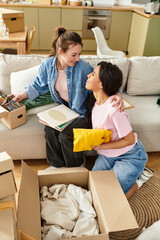 Fototapeta na wymiar Loving couple organizing their new home while sharing smiles and joyful moments together