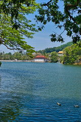 KANDY, SRI LANKA - FEBRUARY 10, 2021: View on Kandy lake and big Buddha on top of the hill. Kandy is home of The Temple of the Tooth Relic, one of the most sacred Buddhist places of worship. 