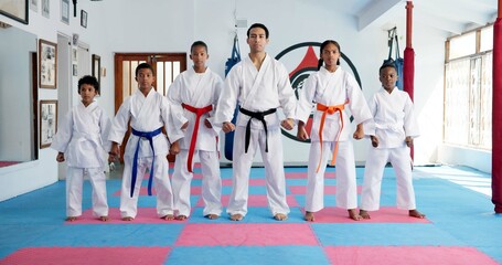 Sensei, portrait and man with children in karate class, self defense or martial arts with youth for combat education. Taekwondo, group and male instructor with student kids for coaching in dojo