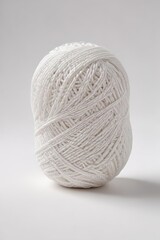 A single ball of white yarn against a seamless white background,  round,  light,  bright