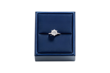 A classic round cut diamond engagement ring in a blue display box transparent background