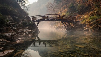 Fototapeta premium A moody morning scene of a wooden bridge over a clear mountain river, with swirling mist creating an enchanting, tranquil environment. 