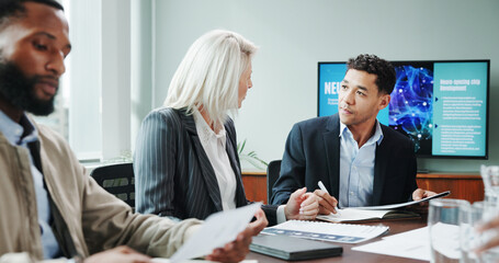 Corporate, people and meeting with document in office for planning, neuroscience and innovation idea. Manager, presentation and briefing with paperwork, brain technology and proposal of neurofeedback