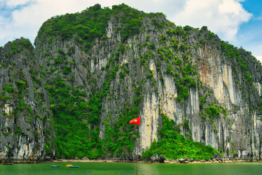 HA LONG BAY, VIETNAM - JULY 19, 2022: Beautiful view of the Halong bay, Vietnam. UNESCO World Heritage. This was on a cloudy day, with many boats and spells of sunshine. during the Covid 19 pandemic.