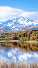Fototapeta premium Autumnal lake reflecting snow-capped mountain