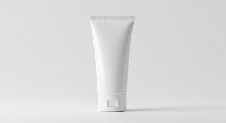 Empty white cosmetic tube product mockup on a plain white background. Modern, minimalist design for beauty product packaging.