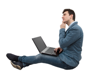 Thinking positive, young businessman sitting down on floor using laptop on his knees, dreaming with hand under chin. Imagining holiday, Network travel concept