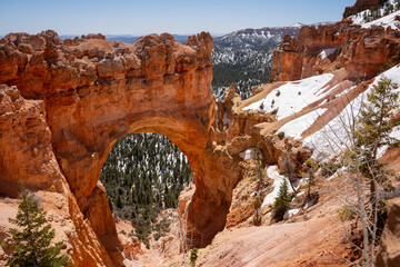 View of Bryce Canyon partially covered with snow. Natural Bridge Viewpoint. Bryce Canyon in May. Utah, USA