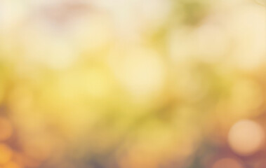 Abstract blurred background with yellow green and orange bokeh lights.