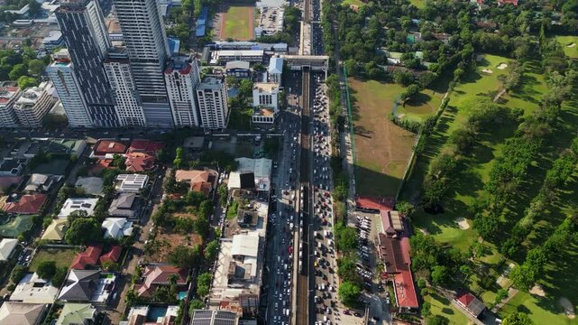 Panoramic overhead drone shot of busy EDSA Epifanio de los Santos Avenue highway roads during daytime - Metro Manila, Philippins