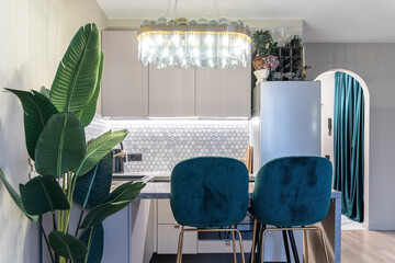 stylish design of small kitchen in shades of gray. Cozy atmosphere in kitchen, dim lights. Grey...