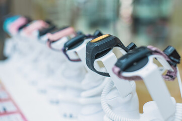 Smartwatches displayed on stands in a store, close-up row.