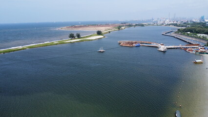 Aerial view shows boats on the blue sea under the summer sky along the coast