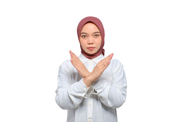 Portrait of young serious Asian Muslim woman showing stop gesture with crossed arms isolated on transparent background