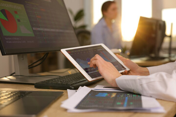 Stock exchange. Woman working at desk in office, closeup