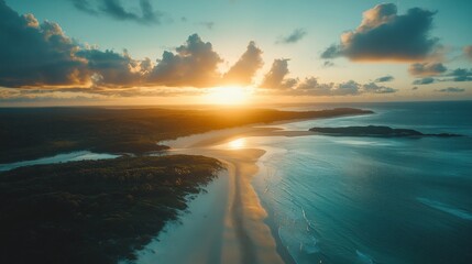 Obraz premium Dramatic coastal sunset over a pristine beach and forest.