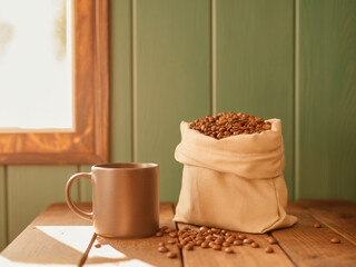 Rustic Coffee Setup with Ceramic Mug and Fresh Beans in Burlap Pouch