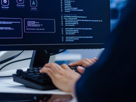 Back View of Professional Ai Software Developer Analyzing Structured Output from AI Assistant, Ai agent chatbot, Writing Code and development on desktop computer. Intelligent Agent System concept.