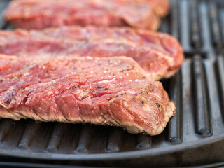 Grilled Steak is Cooking on a Barbecue Grill, creating a delicious aroma in the air