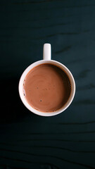Warm Morning Ritual: Steaming Hot Coffee in a White Mug on a Dark Wooden Table