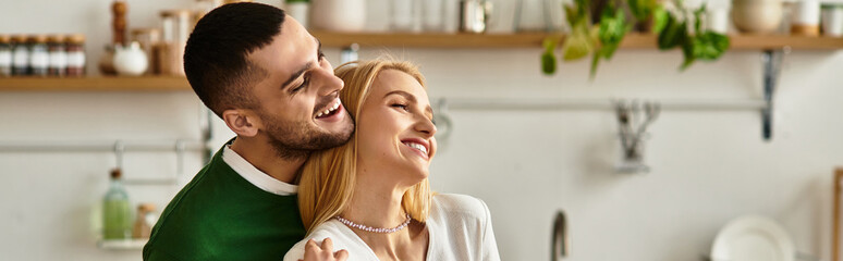 Fototapeta premium Warm moments shared between a loving couple enjoying their cozy home in a joyful embrace